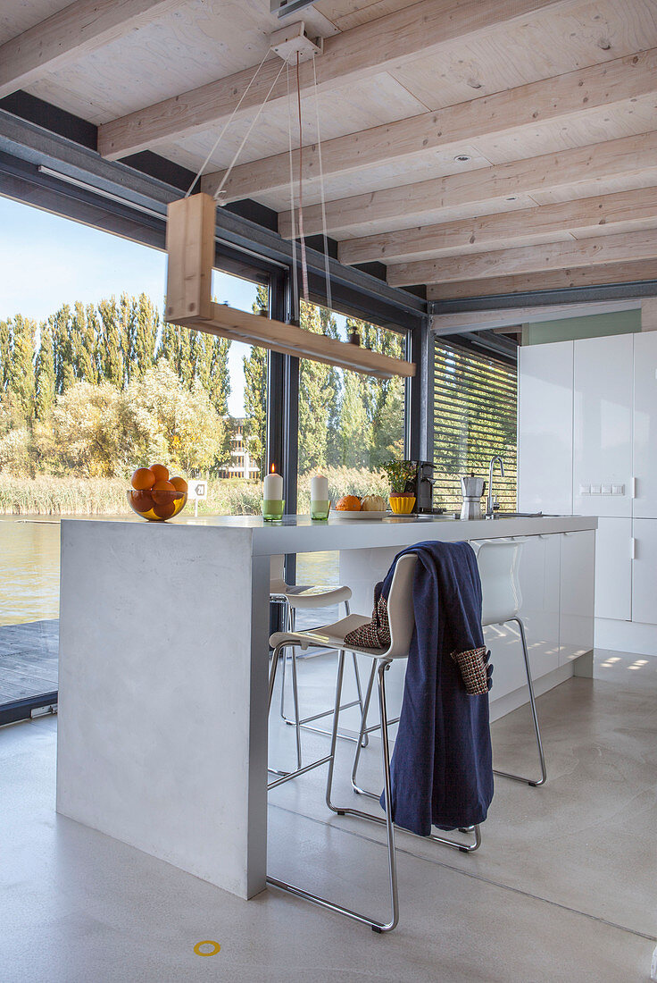 Modern houseboat: kitchen counter, wooden ceiling and glass wall