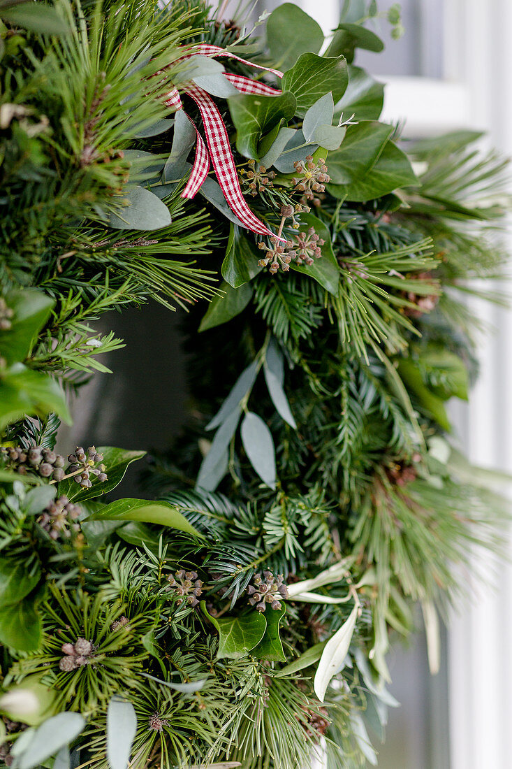 Wreath of pine, ivy, eucalyptus and yew on door