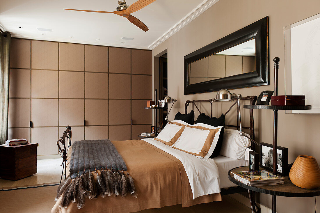 Fitted wardrobes in English-style bedroom in shades of brown