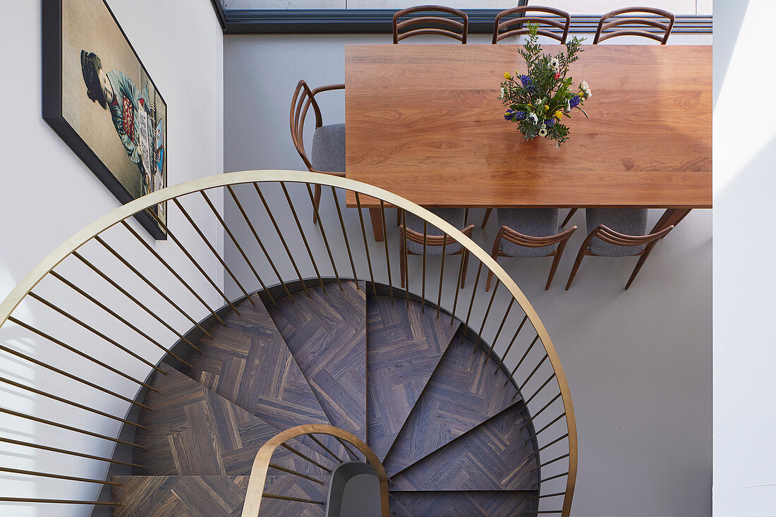 View down spiral staircase to dining table