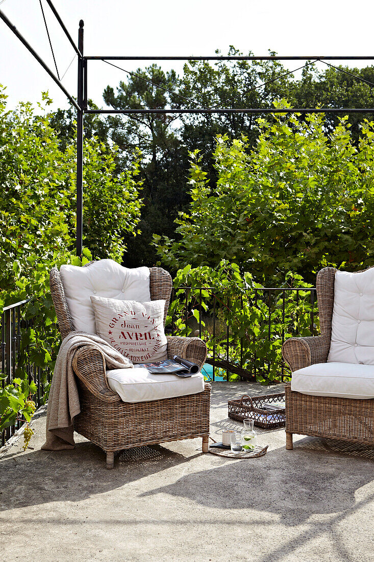 Wicker armchairs on country house terrace