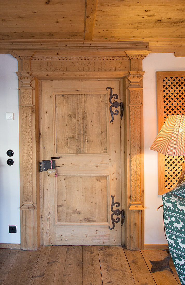 Solid wooden door with iron fittings in traditional Swiss farmhouse