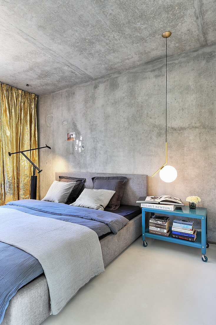 Urban-style bedroom in shades of grey with concrete wall