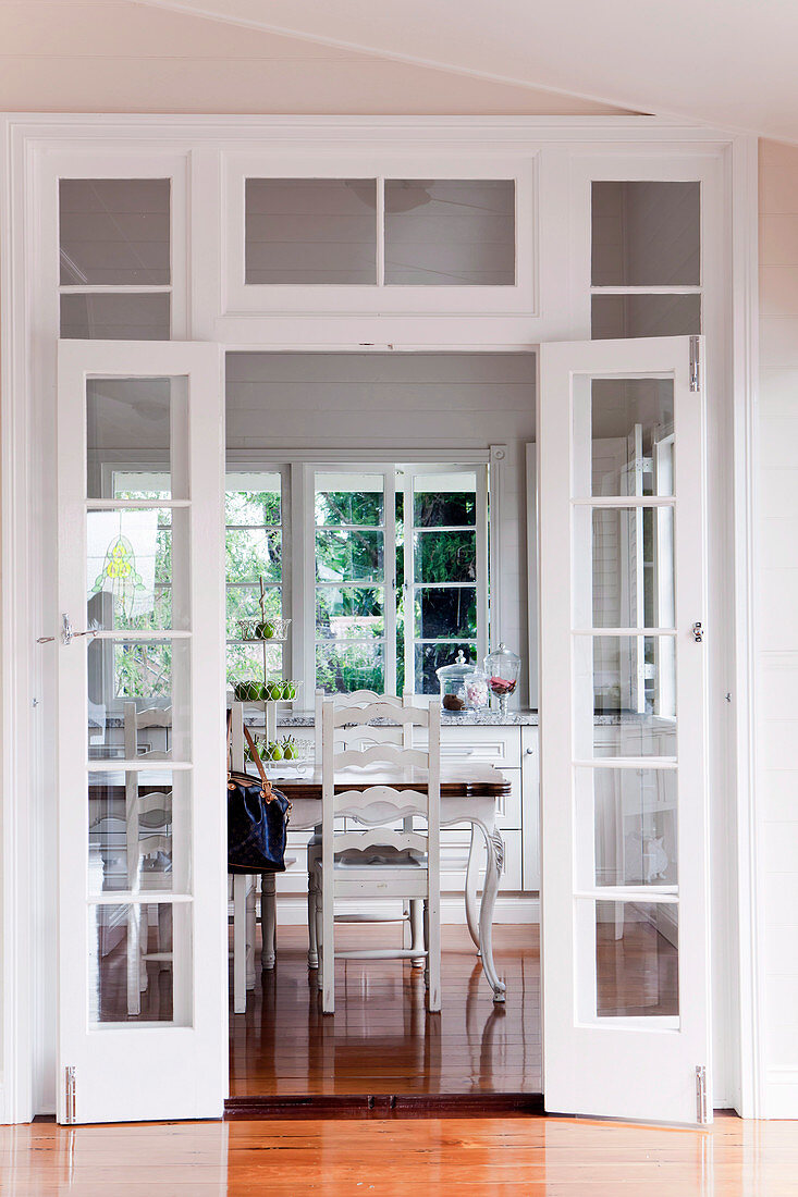 View through open double doors into the dining room of a renovated Queenslander