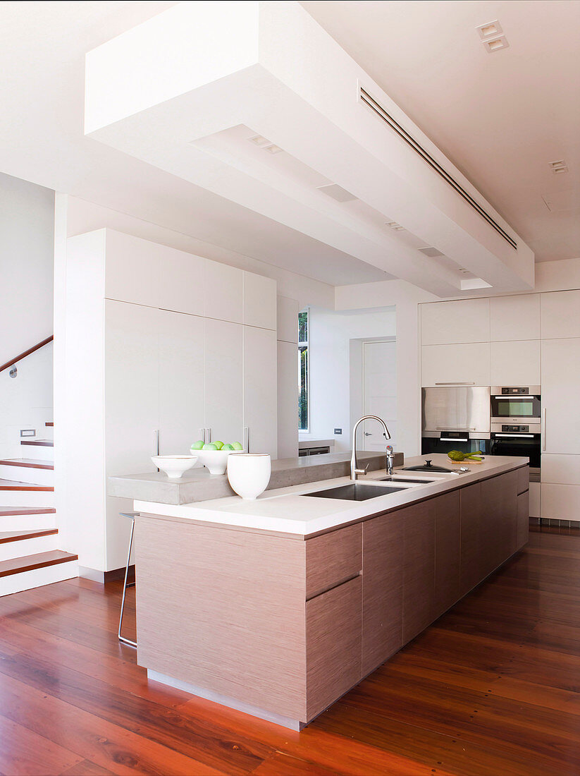 Minimalist modern kitchen with island and dark wooden floor