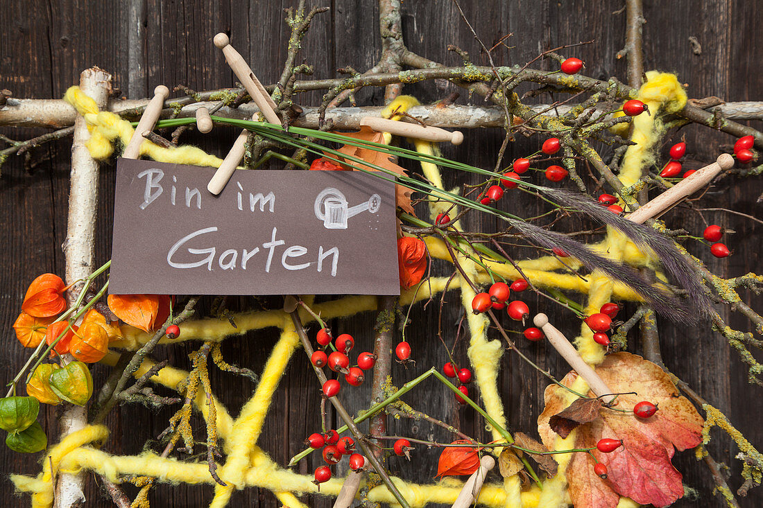 Imaginative, autumnal flower arrangement on bar door