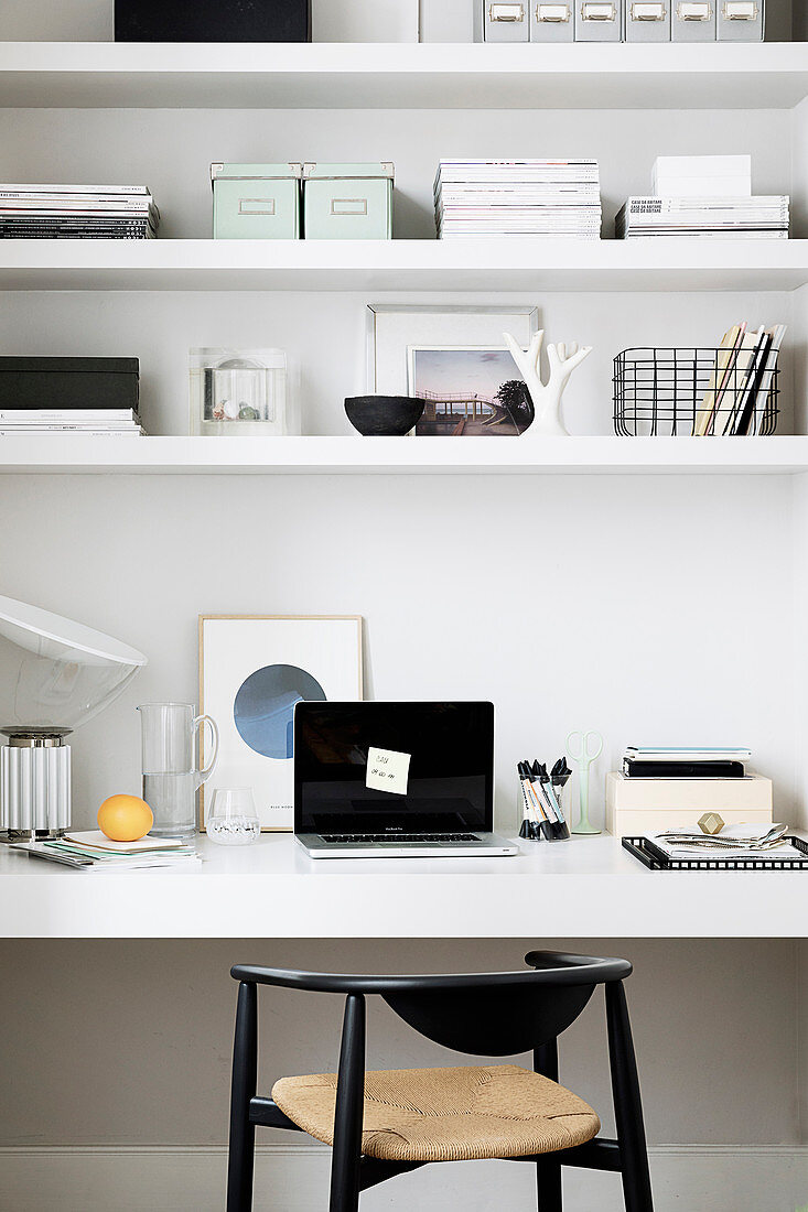 Black and white organisers and ornaments on shelves and desk