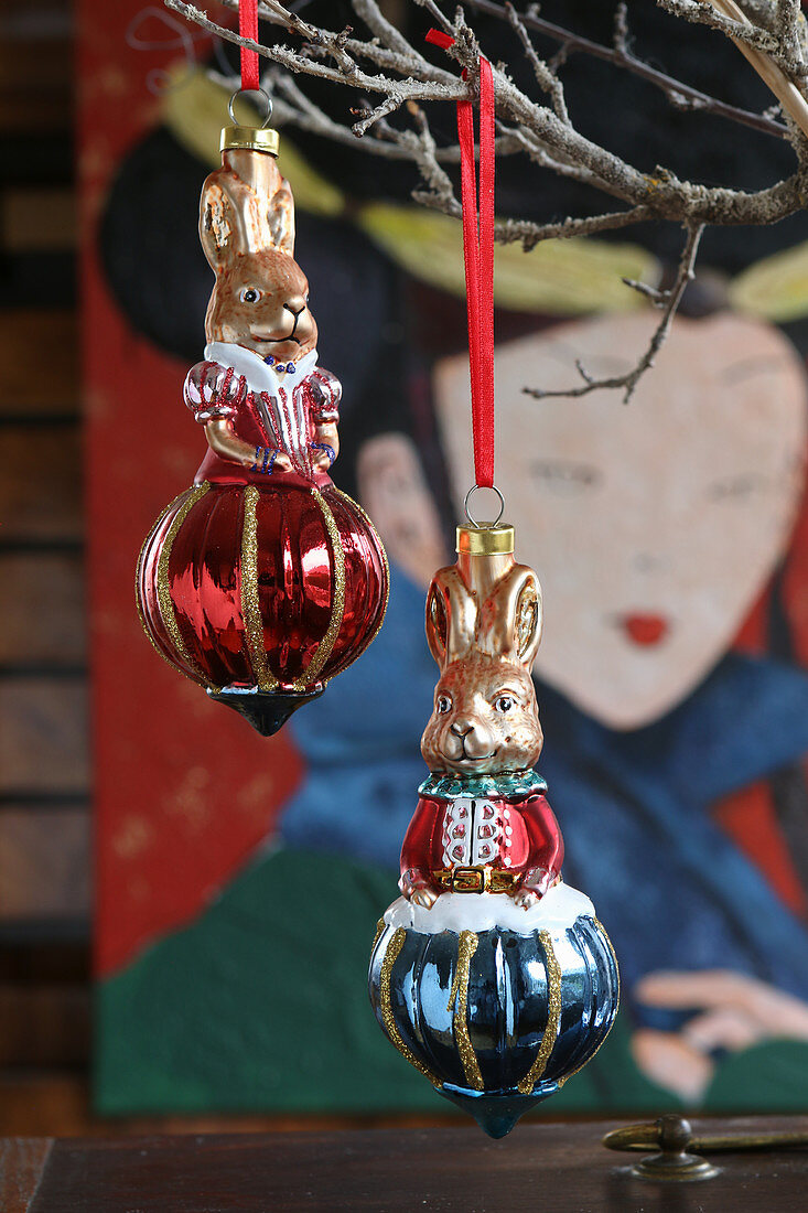 Red and blue rabbit-shaped Christmas-tree baubles hung from twigs