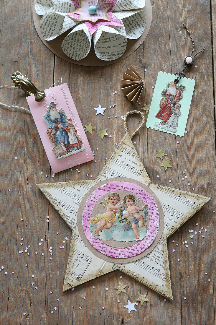 Christmas decoration handcrafted from book pages, scrapbook pictures of Father Christmas and angels and star made from sheet music