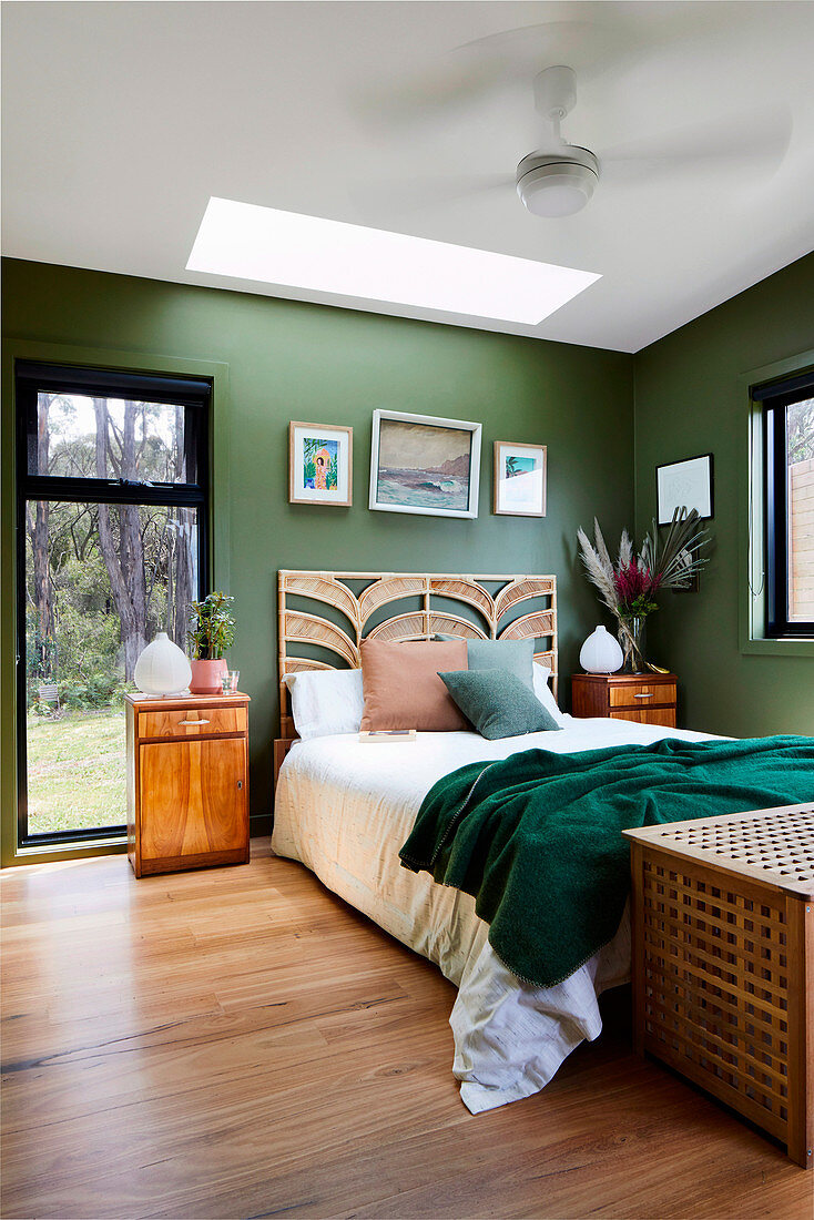 Bedrooms in natural tones with green walls and views of trees