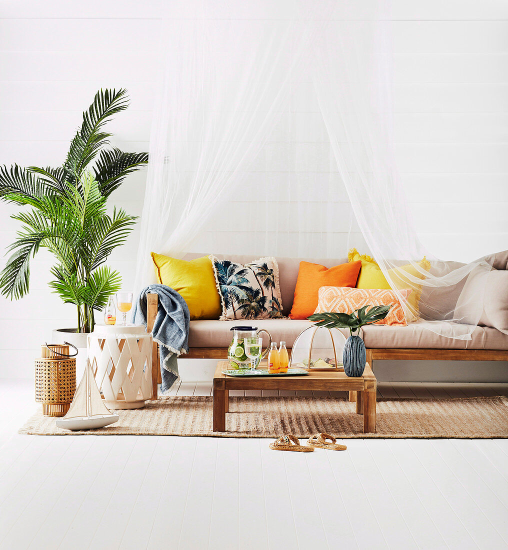 Couch with canopy, coffee table, side table and palm tree