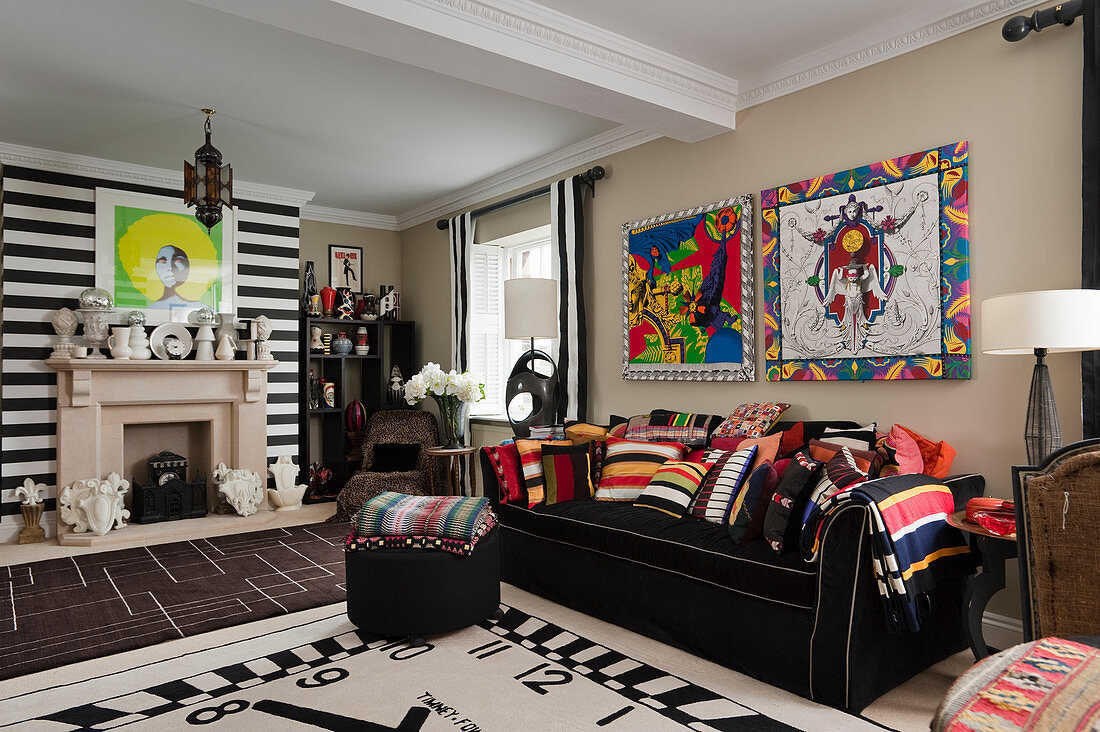 Clock-face rug in front of black sofa with colourful designer scatter cushions