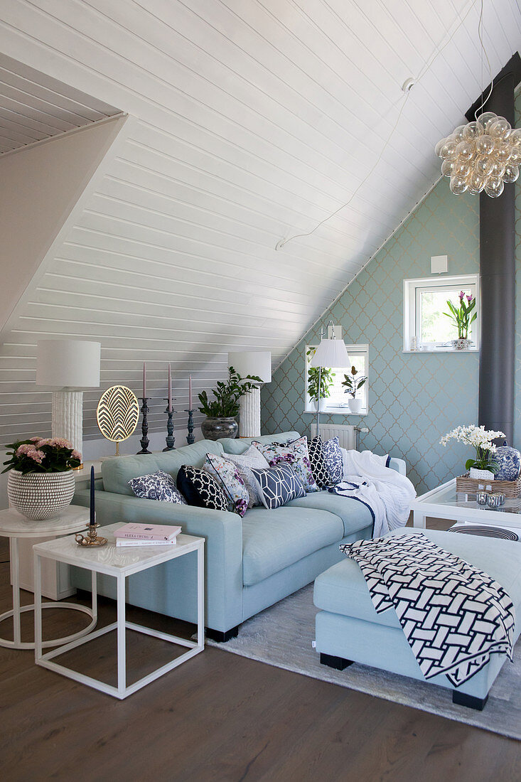 Elegant living room in white and turquoise below sloping ceiling