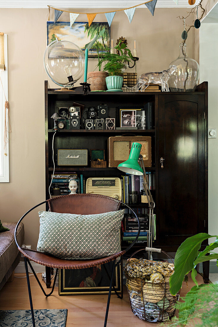 Round chair in front of shelves holding old radios and vintage accessories