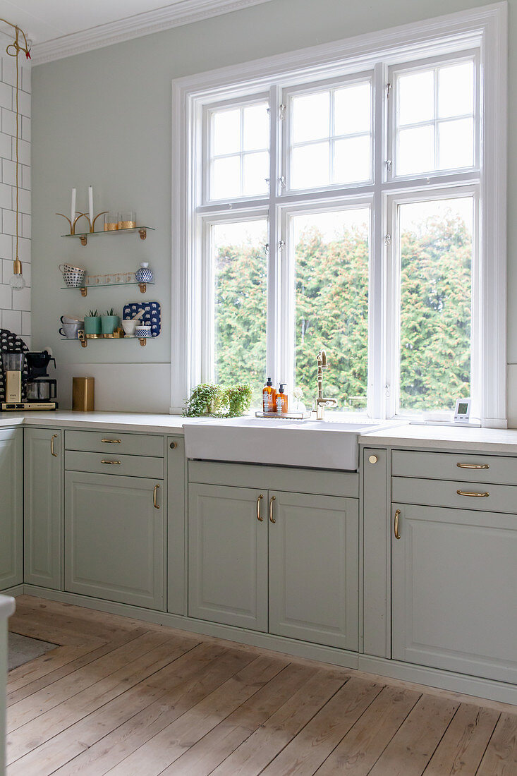 Classic, elegant kitchen in period building with shallow sink below window