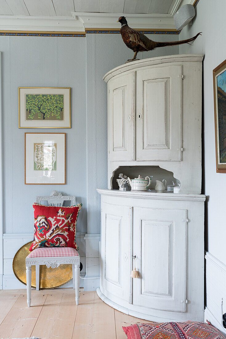 White wooden corner cabinet in renovated Swedish house