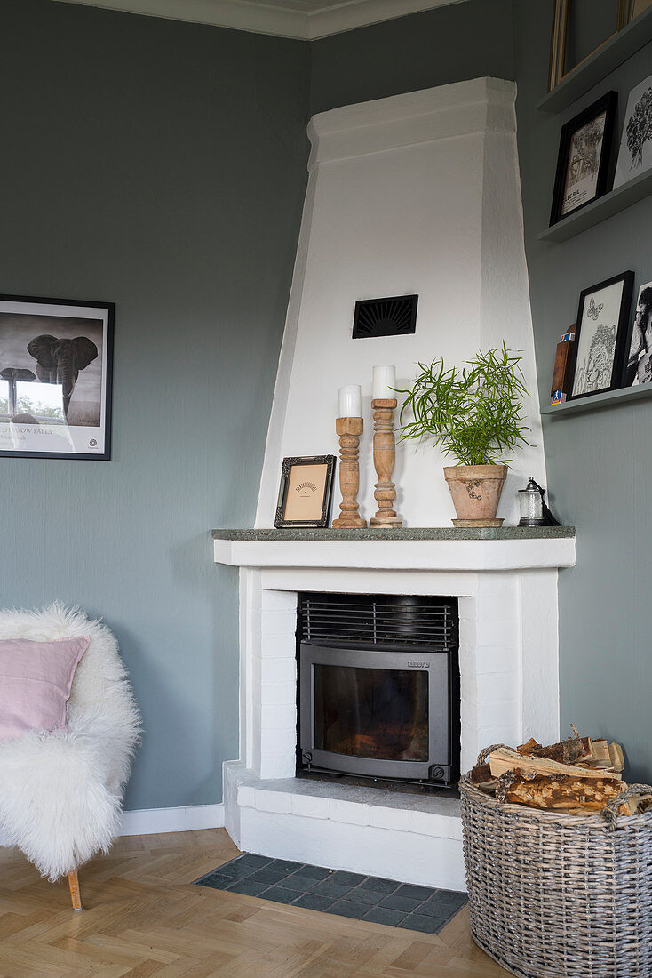 White corner fireplace in interior with grey walls