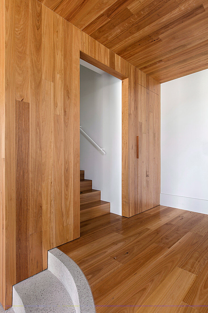 Wood-clad walls and ceilings in the hallway with stairs