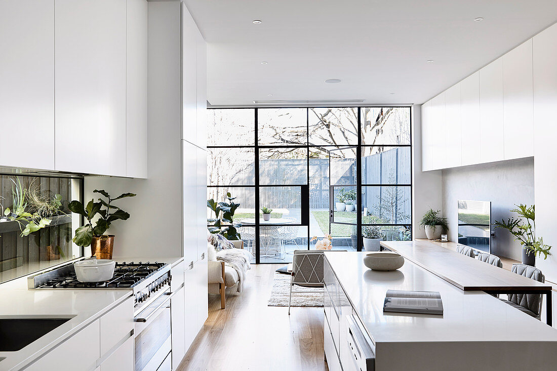 Spacious open white kitchen with island and breakfast bar