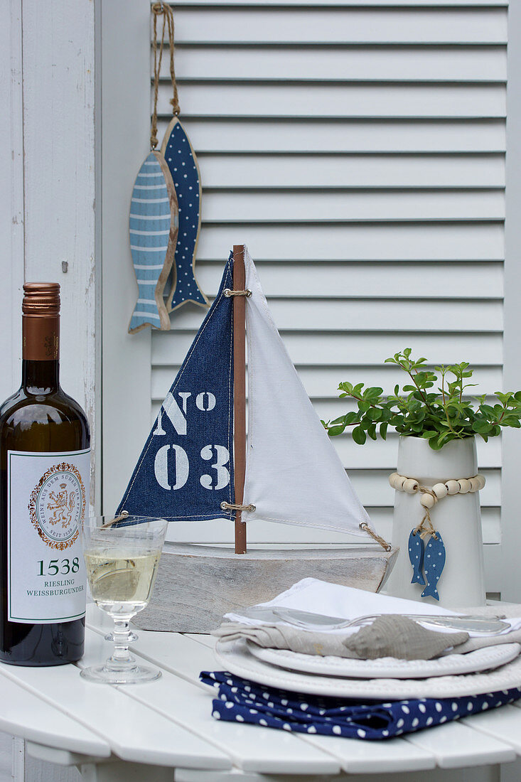 Tisch mit maritimen Accessoires und Weißwein