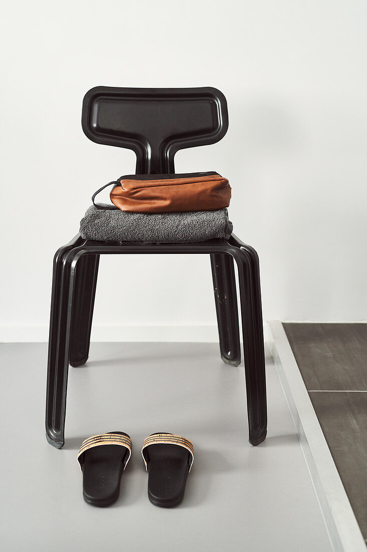 Bathroom utensils on black designer chair