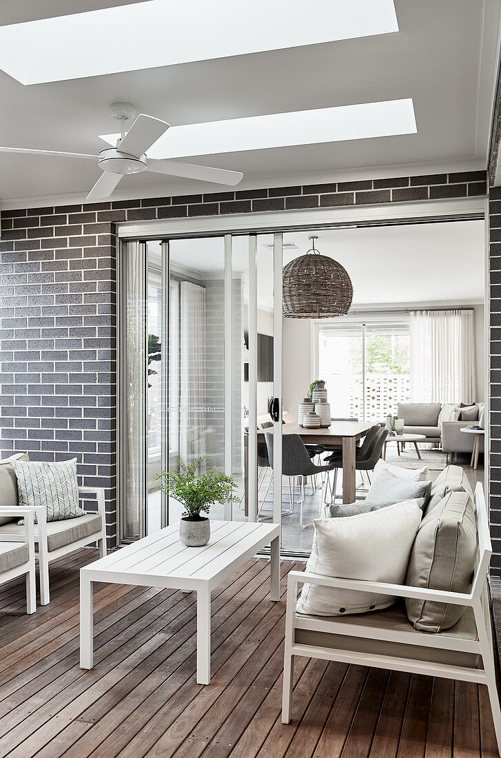 White, wooden outdoor furniture on terrace