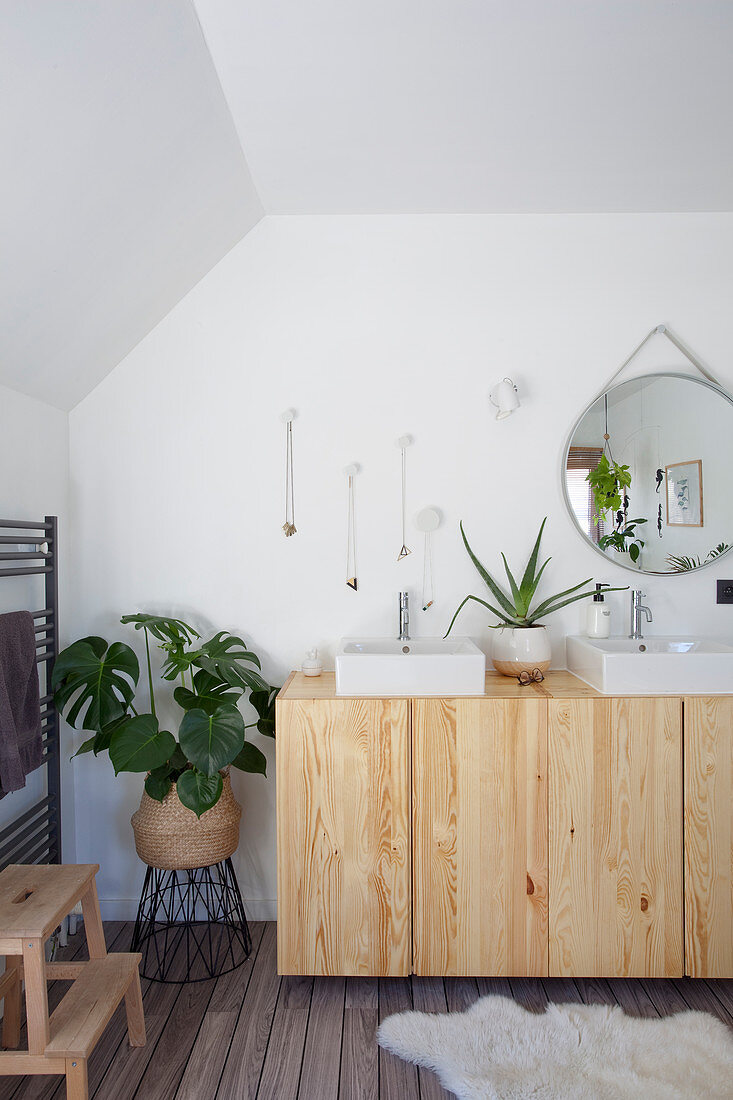 Square countertop sinks on wooden sideboard in bathroom