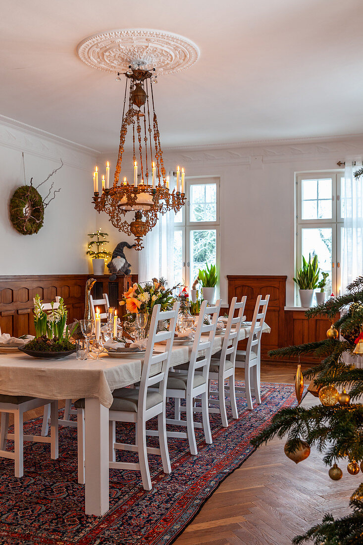 Festively set table in dining room with chandelier