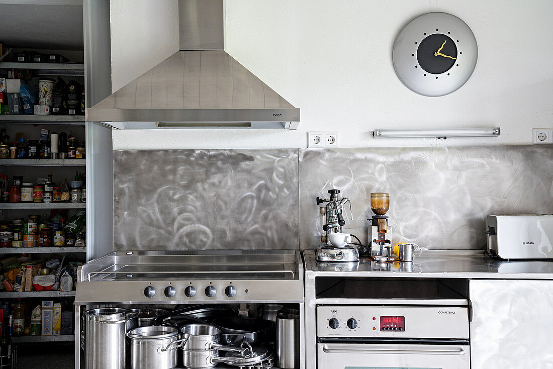 Grey-and-white kitchen with stainless steel units