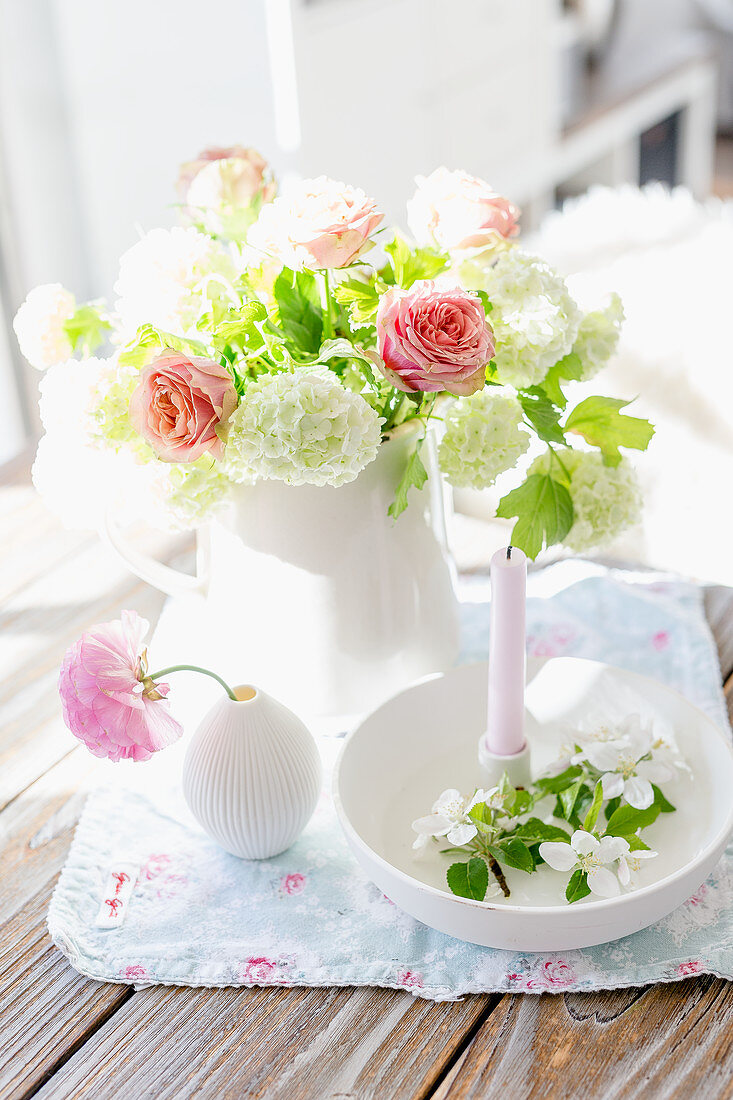 Viburnum and roses in white vase