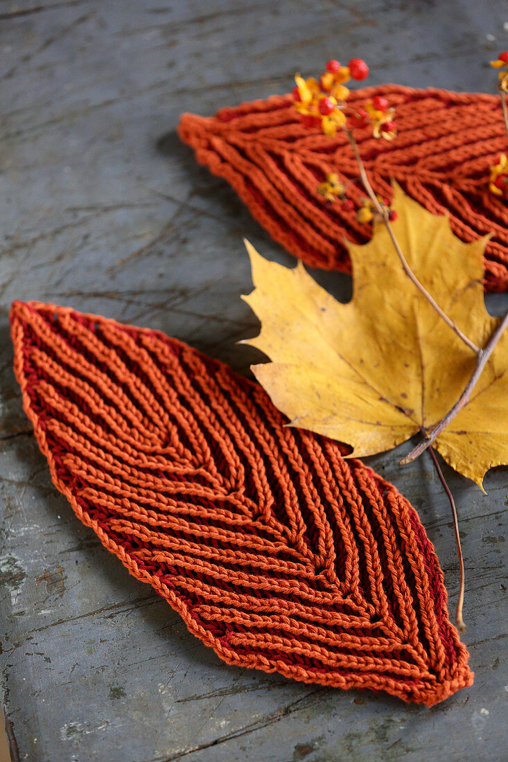 Rusty-red leaf-shaped coasters for decorating autumnal table