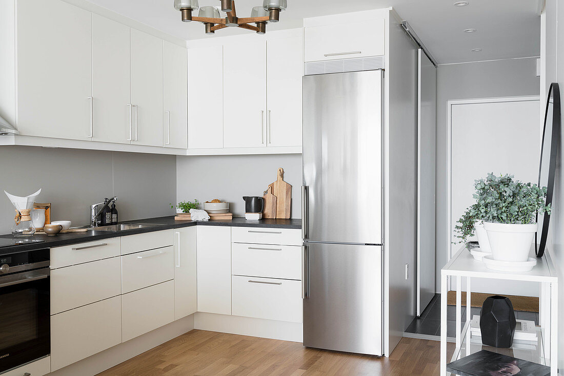 Stainless steel fridge in white, modern kitchen
