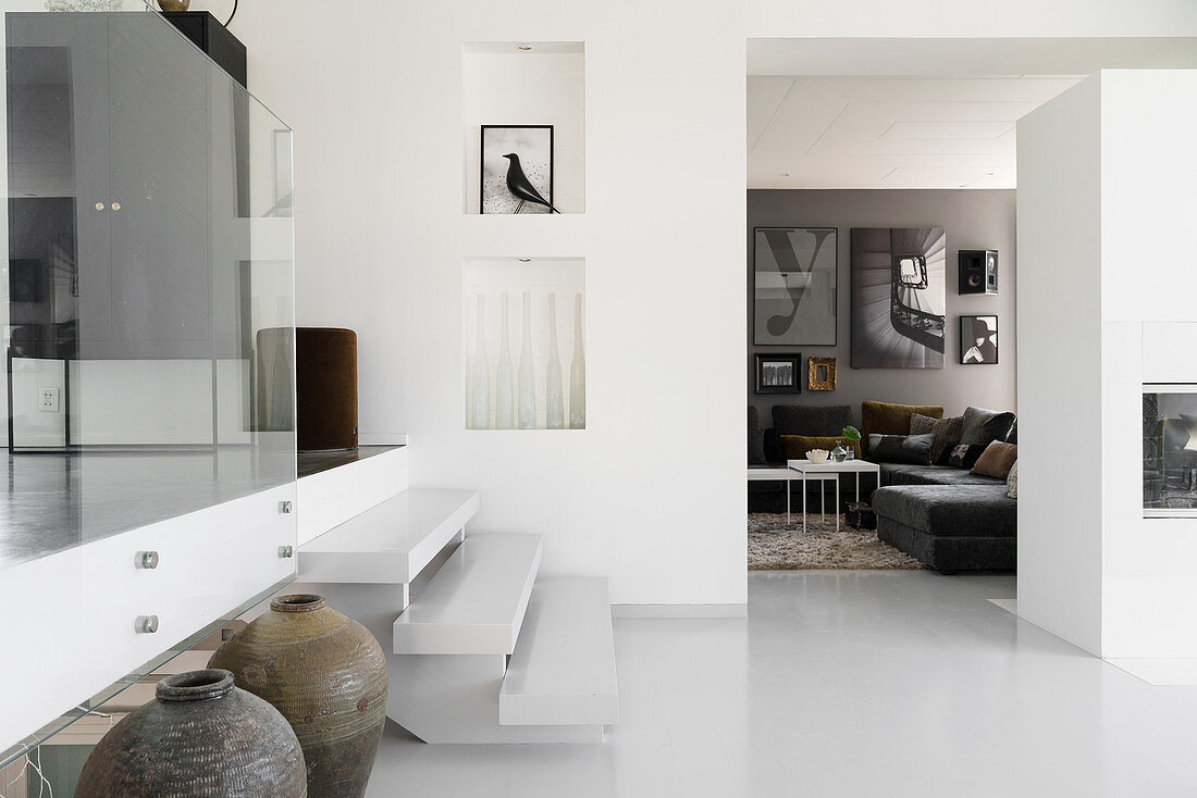 White steps leading to raised level in elegant, open-plan interior