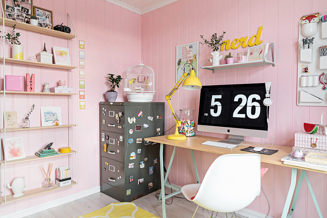 Schreibtisch und Metall-Büroschrank in femininem Zimmer mit rosa Wänden