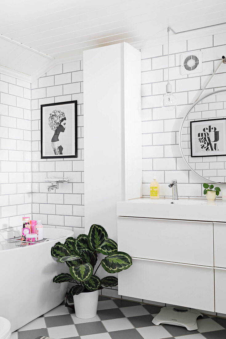 White bathroom with subway wall tiles and simple modern furnishings