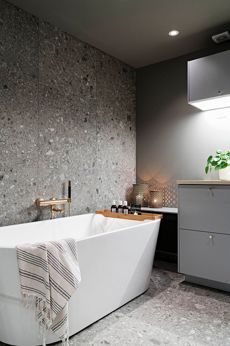 Free-standing bathtub in grey modern bathroom