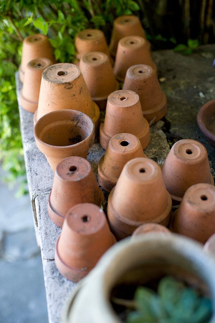 Upturned terracotta plant pots in garden