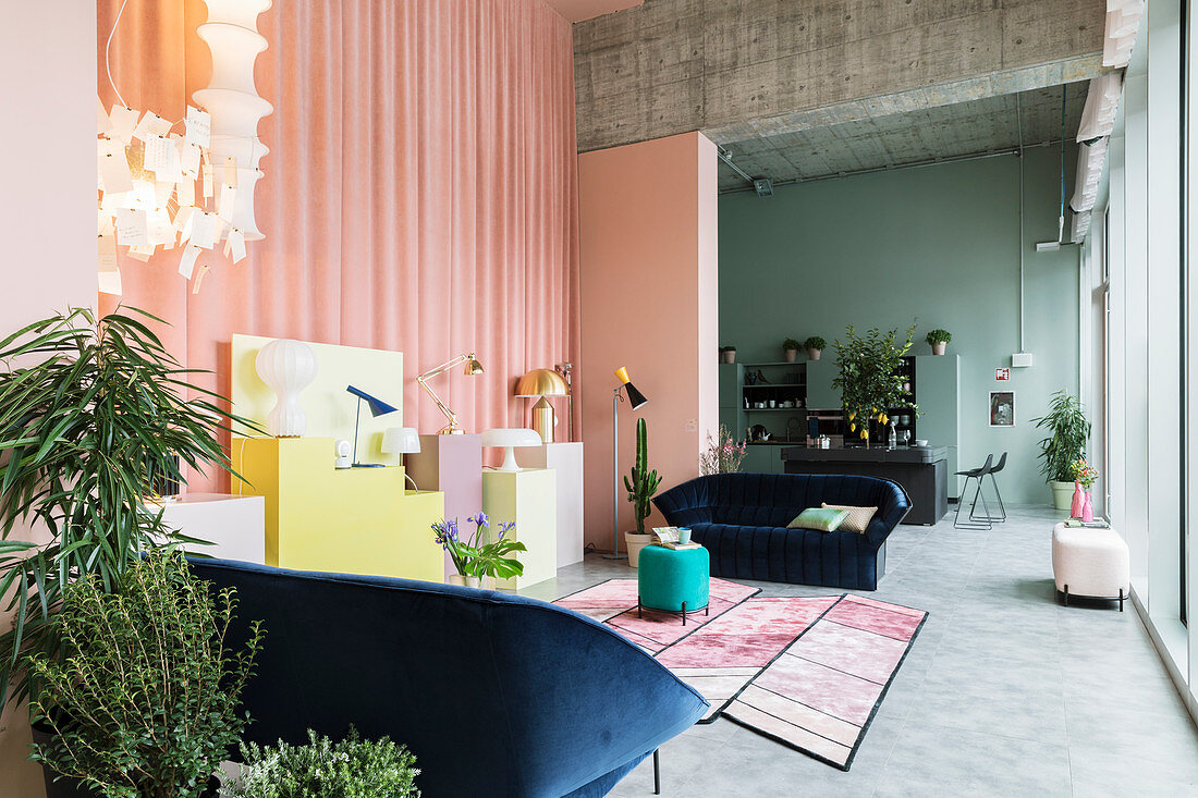 Open-plan interior with walls in pastel shades and exposed concrete ceiling