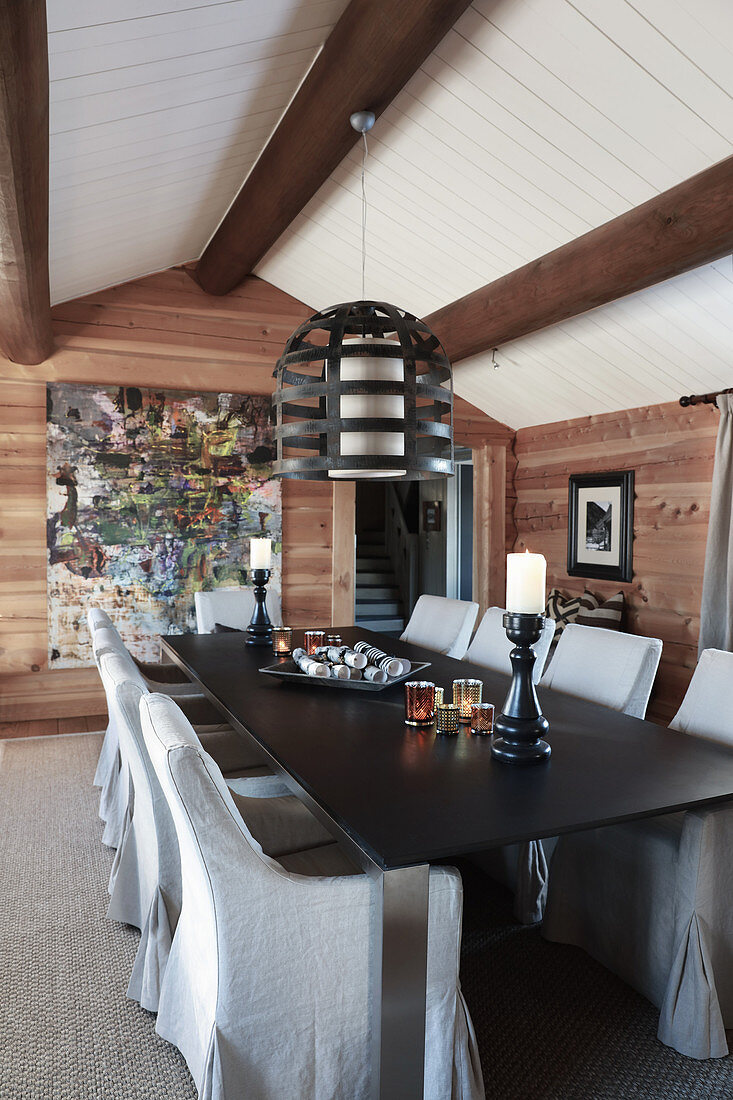 Rustic dining room with open fireplace and exposed ceiling beams