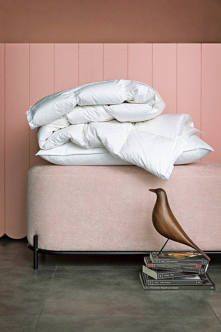Feather pillows on pink ottoman