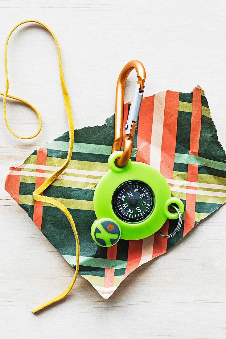 Compass with keychain on wrapping paper