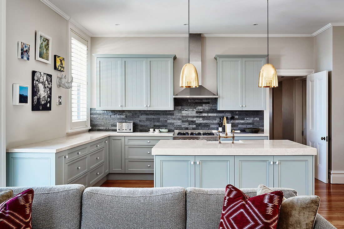 Open-plan country-house kitchen with pale blue cupboards