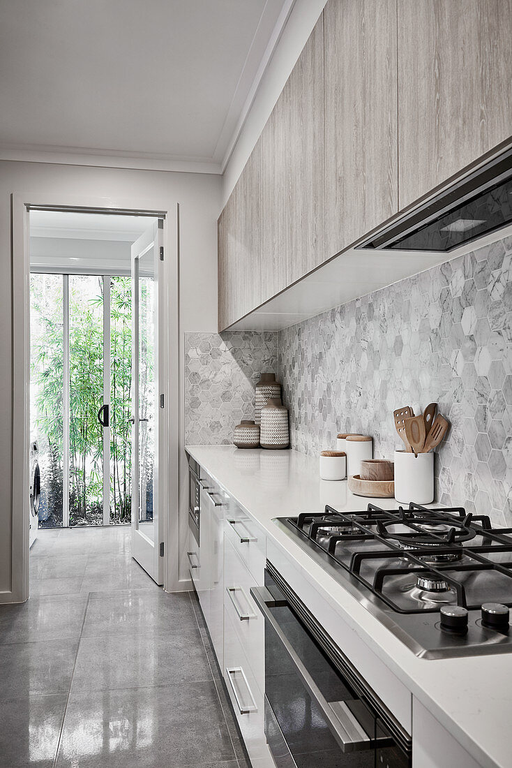 Modern kitchen in shades of grey and white with garden access