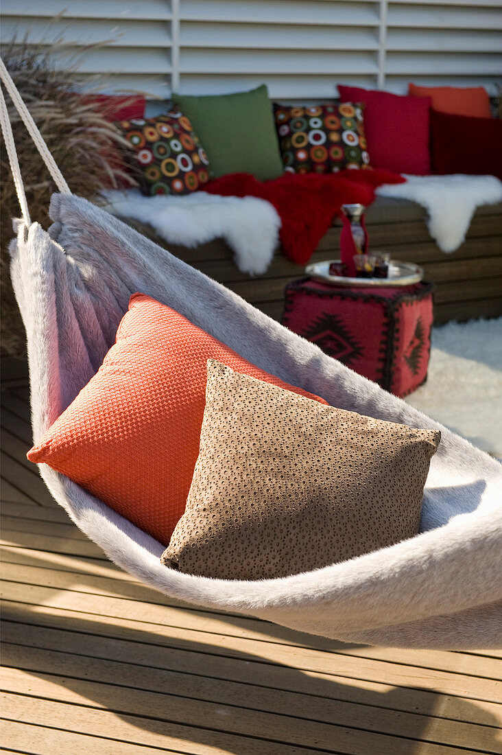 Cushions in fleecy hammock on comfortable terrace
