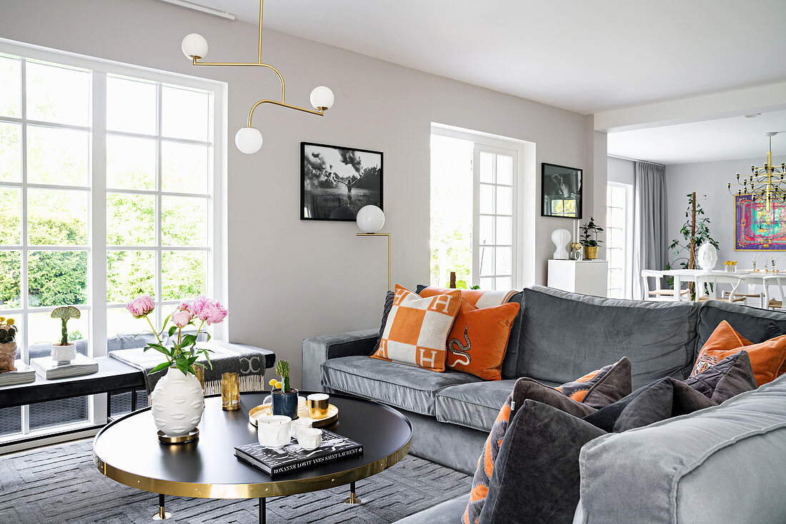 Grey velvet sofa in elegant open-plan interior