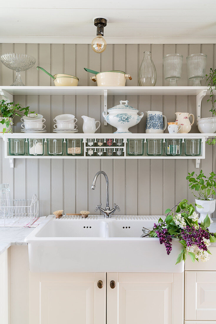 Kitchen sink and wall-mounted shelves in Scandinavian country-house kitchen