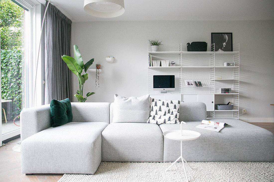 Modernes graues Sofa im minimalistischen Wohnzimmer