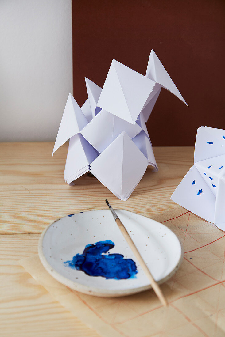 Paper ornaments with blue paint