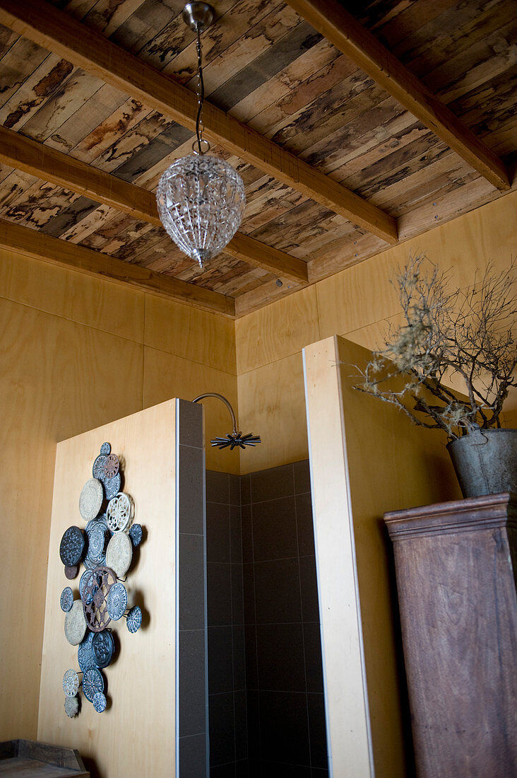 Shower cubicle in bathroom with rustic wooden ceiling