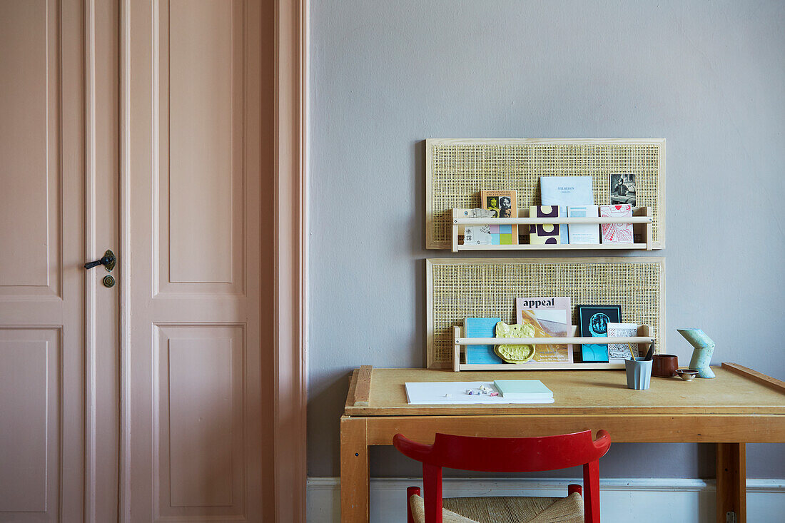 Woven panels and shelves on wall above desk